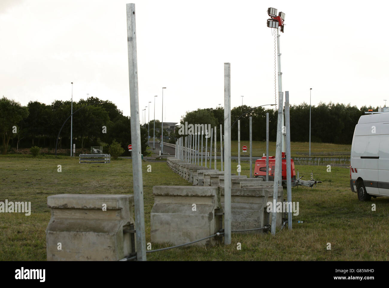The foundations for a new section of fence to reinforce security, next to the perimeter fence of the Eurotunnel site at Coquelles in Calais, France. PRESS ASSOCIATION Photo. Picture date: Thursday July 30, 2015. Photo credit should read: Yui Mok/PA Wire Stock Photo