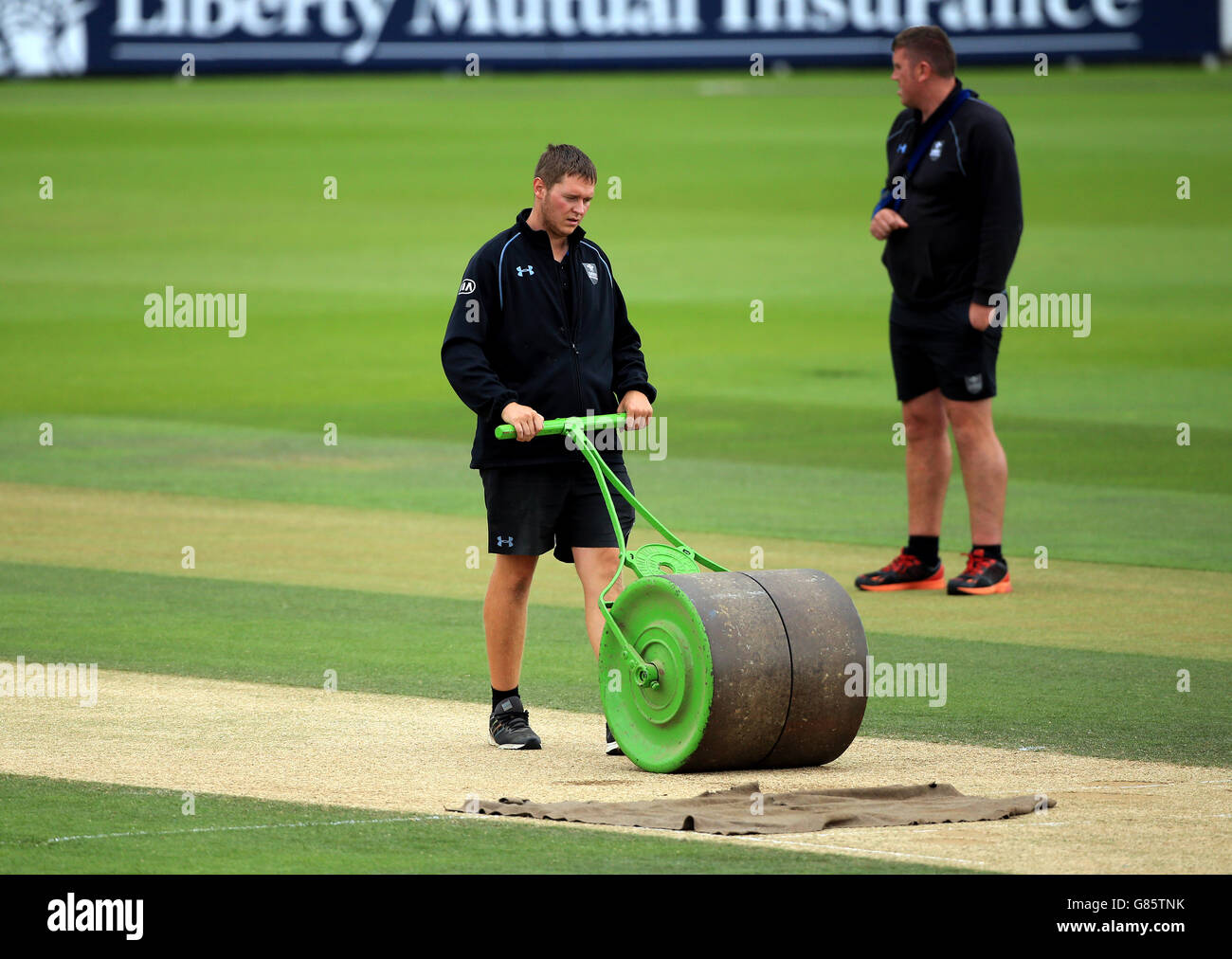 Surrey's ground staff roll the wicket before the match Stock Photo