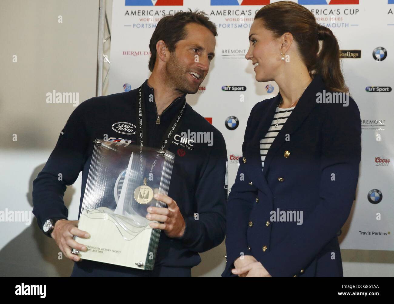 The Duchess of Cambridge presents the Portsmouth Victory Trophy to Ben Ainslie, skipper of Britain's Land Rover backed BAR (Ben Ainslie Racing) team, at the close of the second day of the opening leg of the America's Cup World Series being staged in waters off Portsmouth. Stock Photo