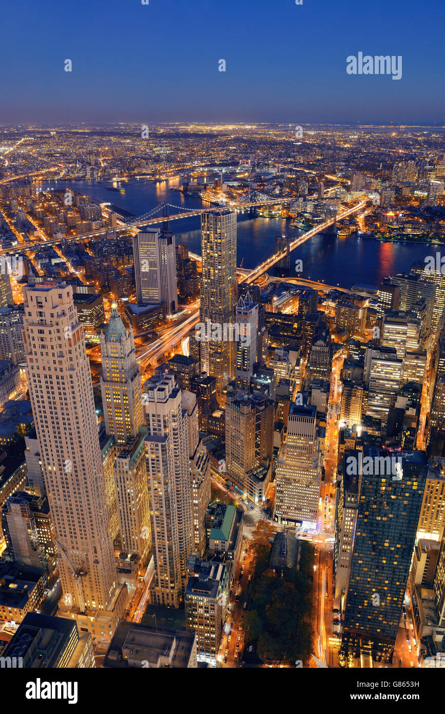 Rooftop at dusk view of New York City downtown with urban skyscrapers ...