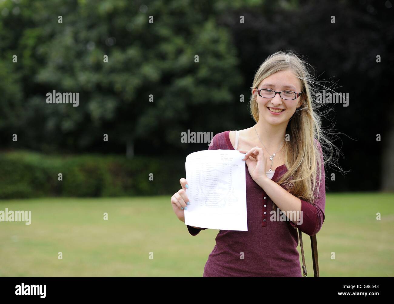 Student Rebecca Carter, 18, who achieved 5 A*'s and will go to Oxford University to study maths, holds her A-level results at Chelmsford County High School for Girls. Stock Photo