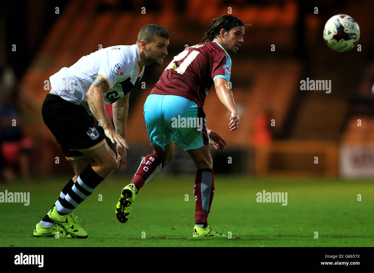 Burnley's George Boyd battles for the ball with Port Vale's Carl Dickinson (left) during the Capital One Cup, First Round match at Vale Park, Stoke-on-Trent. Stock Photo