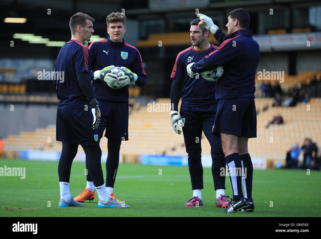 Burnley goalkeeper coach Billy Mercer talks with goallkeeper Daniel Nizic, Matt Gilks (2nd right) and Tom Heaton (left) during the Capital One Cup, First Round match at Vale Park, Stoke-on-Trent. Stock Photo