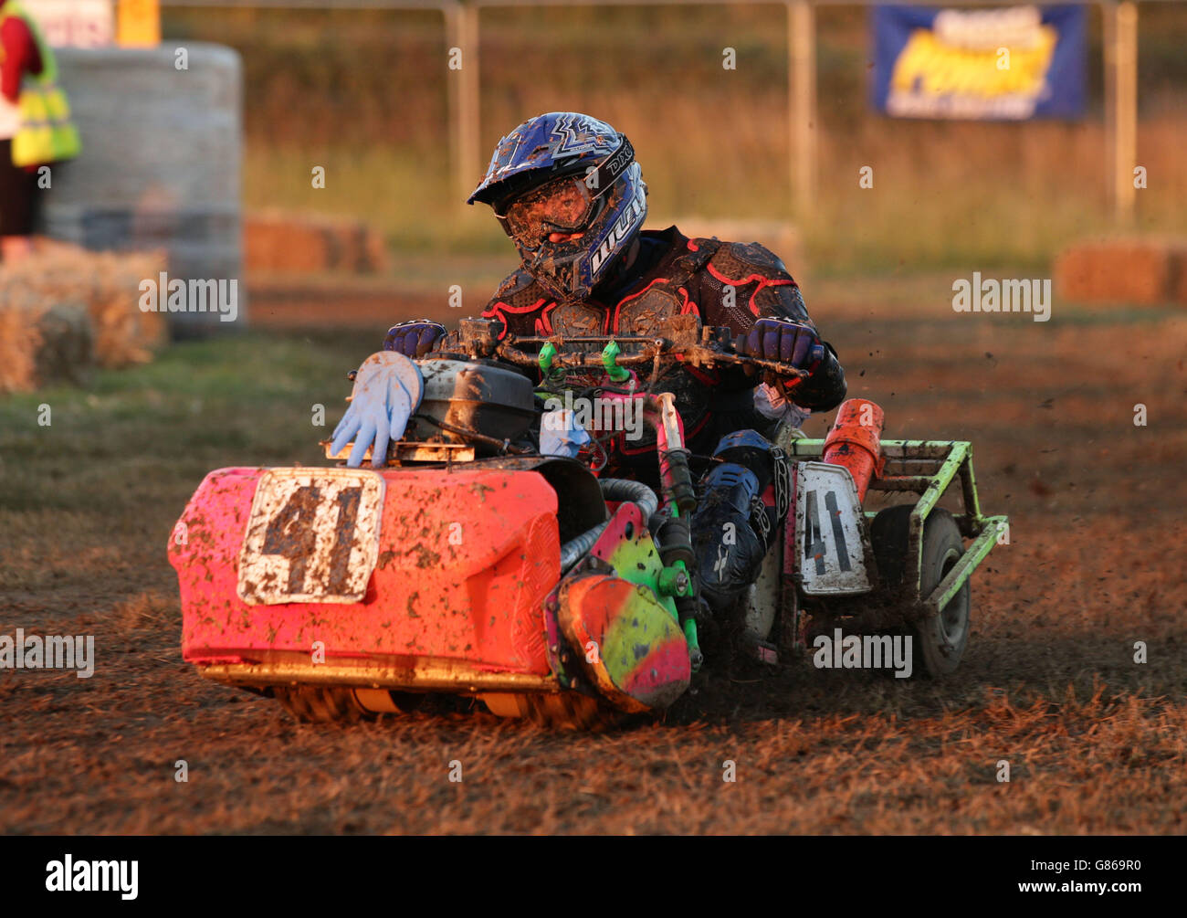 Drivers on their lawnmowers racing into the night, during the BLMRA 12 ...