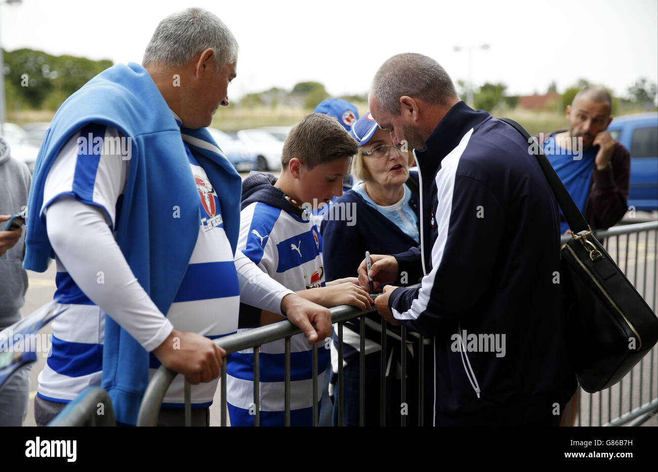 Soccer - Capital One Cup - First Round - Colchester United v Reading - Weston Homes Community Stadium. Reading's manager Steve Clarke signs an autograph for a fan Stock Photo