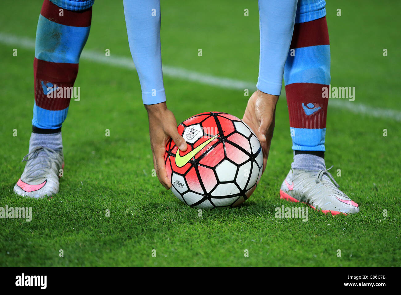 Detail of an Aston Villa player picking the ball up from the turf during Barclays Premier League match at Villa Park, Birmingham. PRESS ASSOCIATION Photo. Picture date: Friday August 14, 2015. See PA story SOCCER Villa. Photo credit should read: Nick Potts/PA Wire. RESTRICTIONS: . Maximum 45 images during a match. No video emulation or promotion as 'live'. No use in games, competitions, merchandise, betting or single club/player services. No use with unofficial audio, video, data, fixtures, or club/league logos. Stock Photo