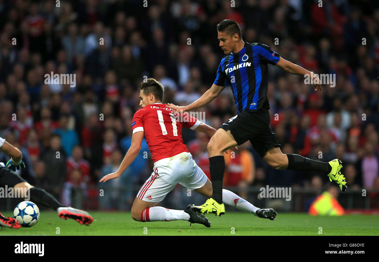 Club Brugge's Oscar Duarte (right) and Manchester United's Adnan Januzaj tangle in the penalty area during the UEFA Champions League Qualifying, Play-Off at Old Trafford, Manchester. Stock Photo