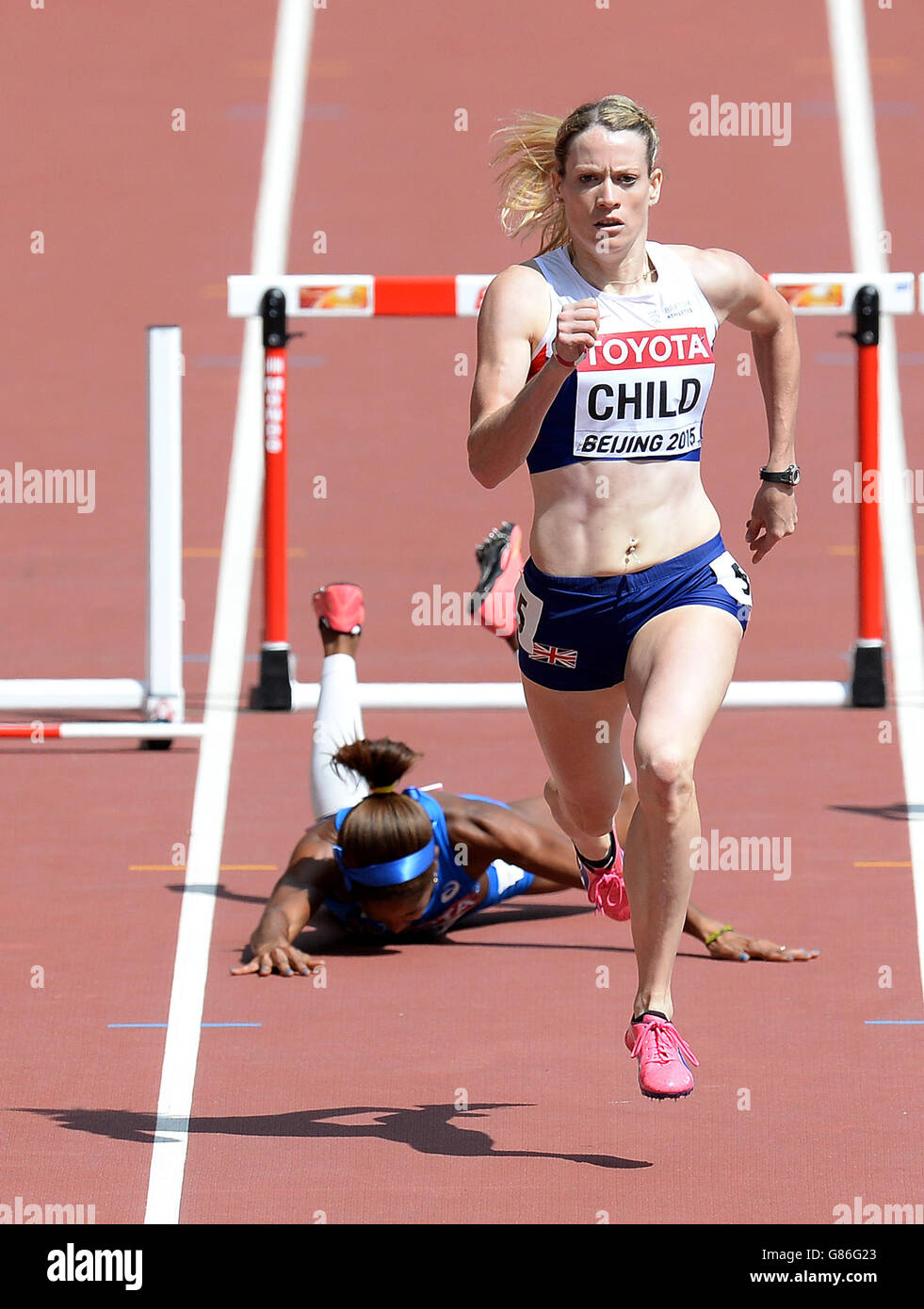 Great Britian's Eilidh Child sprints for the line as Italy's Yadisleidis Pedroso falls after hitting the final hurdle, in heat 2 of the Women's 400m Hurdles, during day two of the IAAF World Championships at the Beijing National Stadium, China. Stock Photo