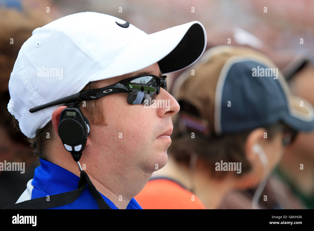 An England fan listening to commentary through a radio earpiece as he  watches the game Stock Photo - Alamy