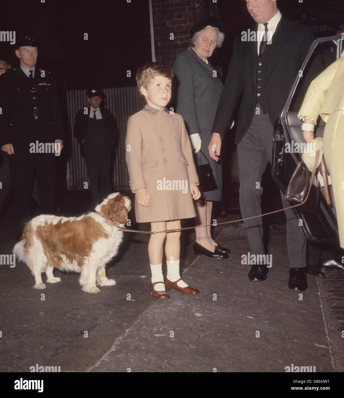 Viscount Linley with his pet dog, 'Rollo', a King Charles Spaniel, as he arrives at London Kings Cross station with his mother Princess Margaret (not pictured) following their holiday at Balmoral. Stock Photo