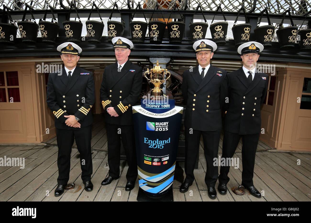 Naval Officers (left-right) Mark Deller, John Cunningham, Keith Beckett and  Paul Nelson next to the Webb Ellis Cup on board HMS Victory in Portsmouth  on day 78 of the 100 day Rugby