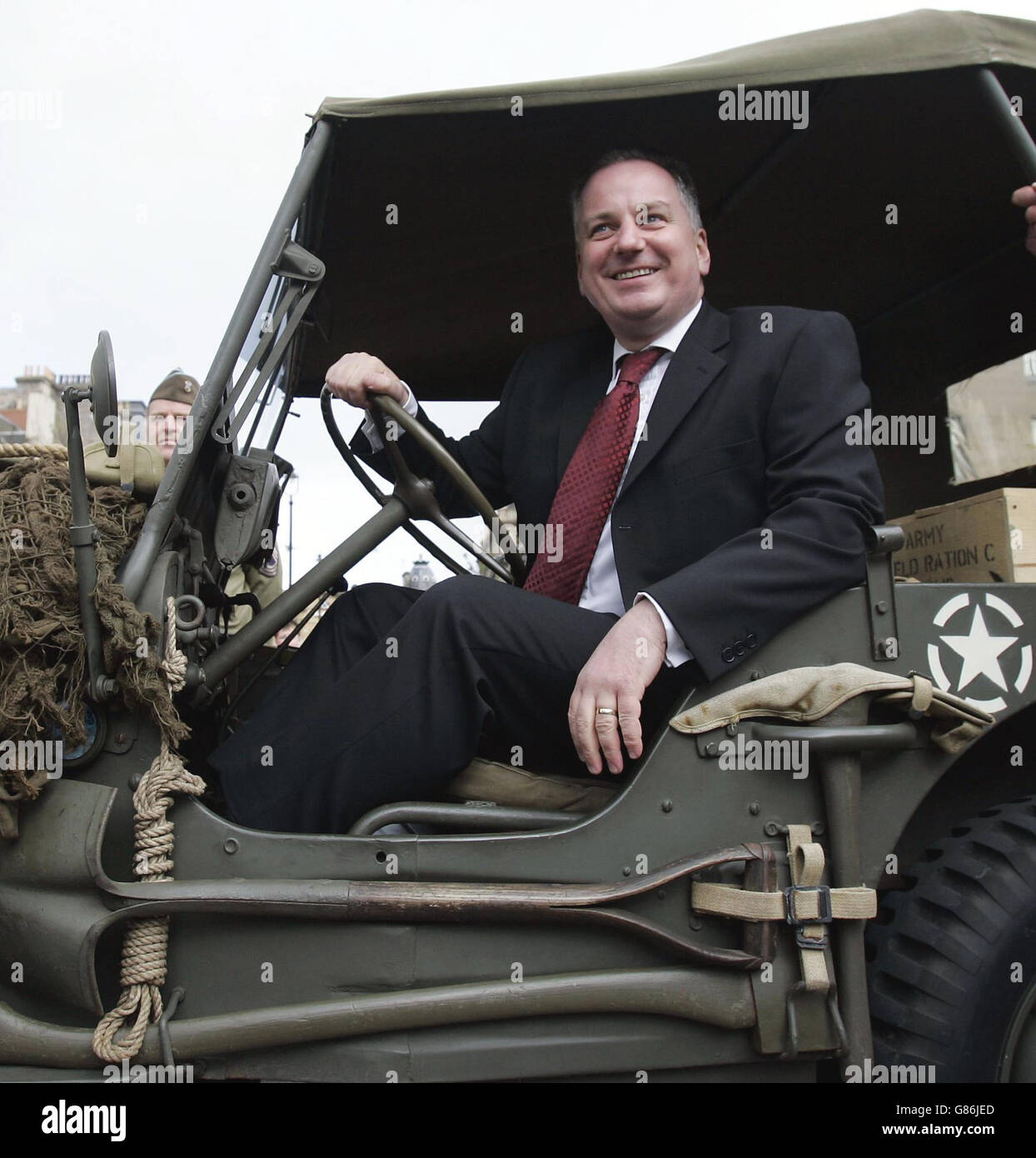 Scotland's First Minister Jack McConnell sits in an army jeep after a VE Day memorial service. At the service in St Andrew's Cathedral, Scottish First Minister JackMcConnell read a lesson, before laying a wreath on behalf of the people of Scotland. Stock Photo