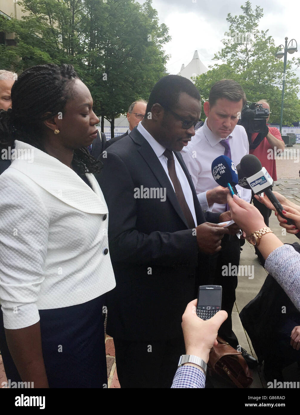 Vincent Uzomah, with his wife Uduak, making a statement outside Bradford Crown Court after a 14-year-old boy who bragged on Facebook about stabbing the supply teacher in a racially motivated attack has been sentenced to 11 years detention. Stock Photo