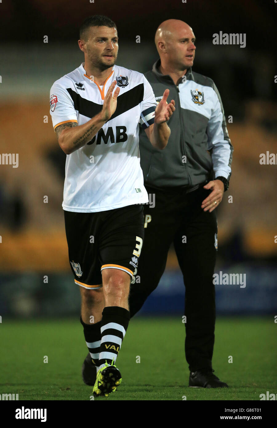 Port Vale captain Carl Dickinson thanks the fans with Manager Robert Page after the Capital One Cup, First Round match at Vale Park, Stoke-on-Trent. Stock Photo