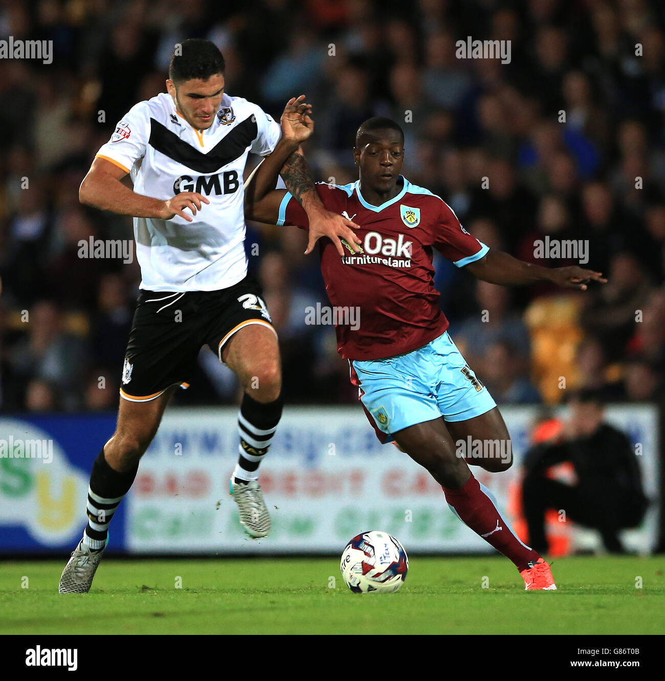 Burnley's Marvin Sordell battles for the ball with Port Vale's Ryan Inniss during the Capital One Cup, First Round match at Vale Park, Stoke-on-Trent. Stock Photo