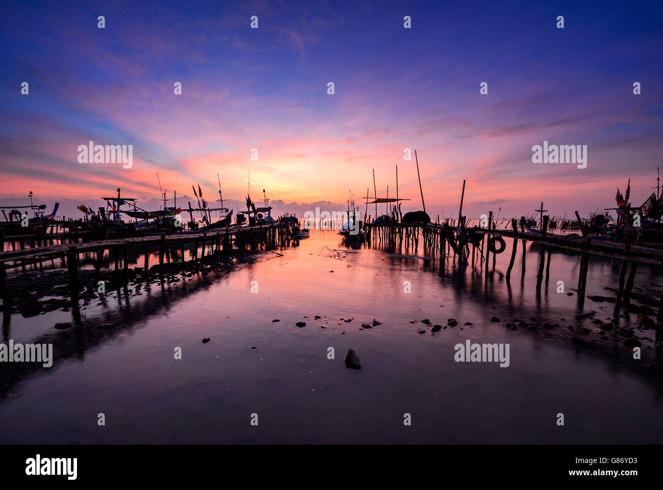 Fishing boats moored along jetty, Thailand Stock Photo
