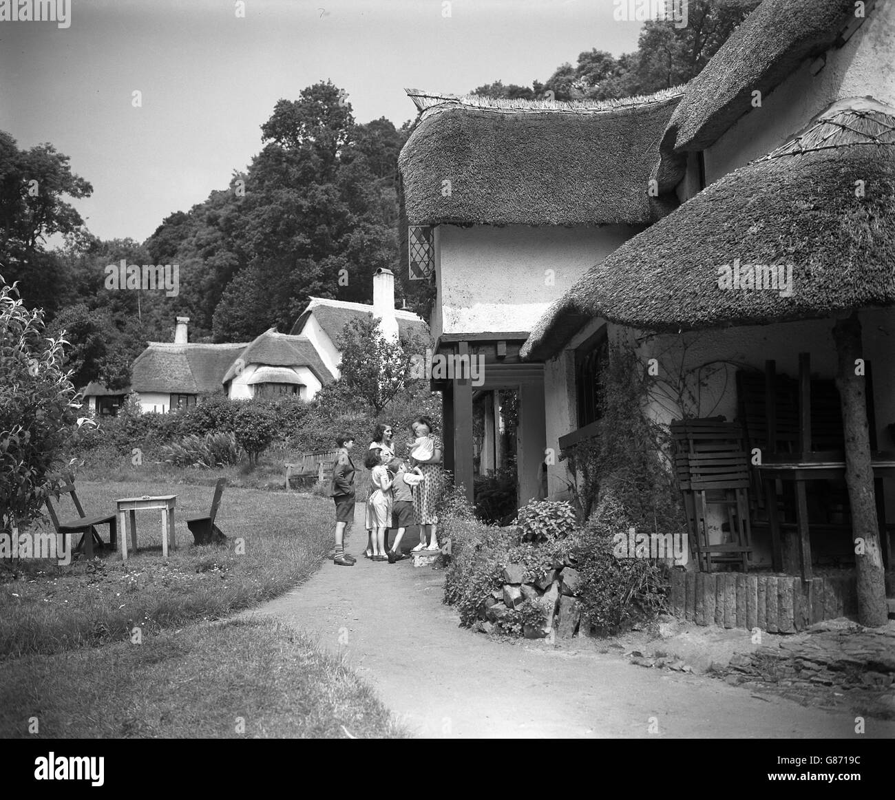 Thatched cottages in the village of Selworthy, Somerset, a place popular with tourists and artists. Stock Photo
