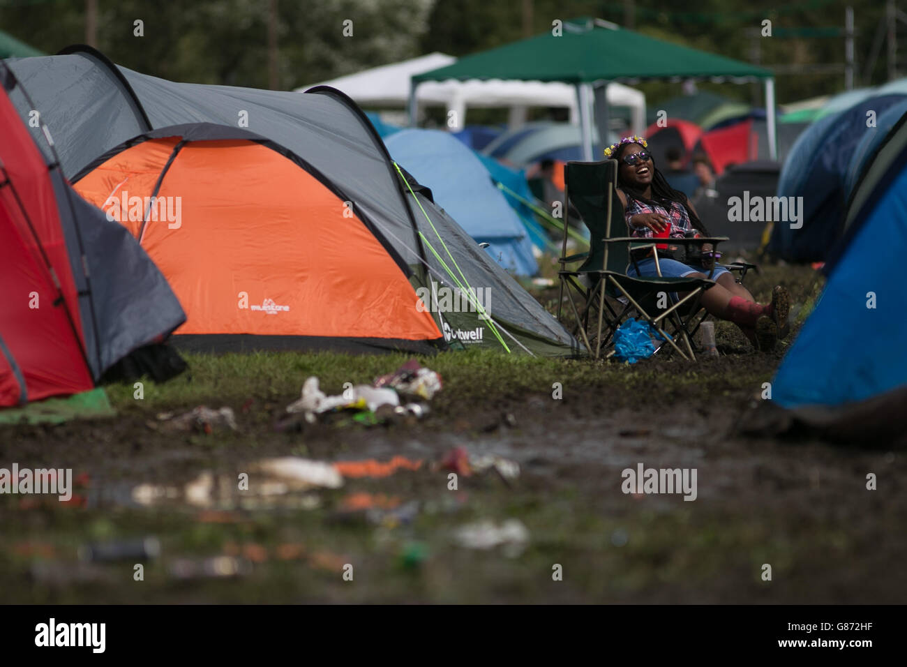 Reading Festival 2015. A music fan rest outside her tent at the campsite on the first day of the Reading Festival in Berkshire. Stock Photo