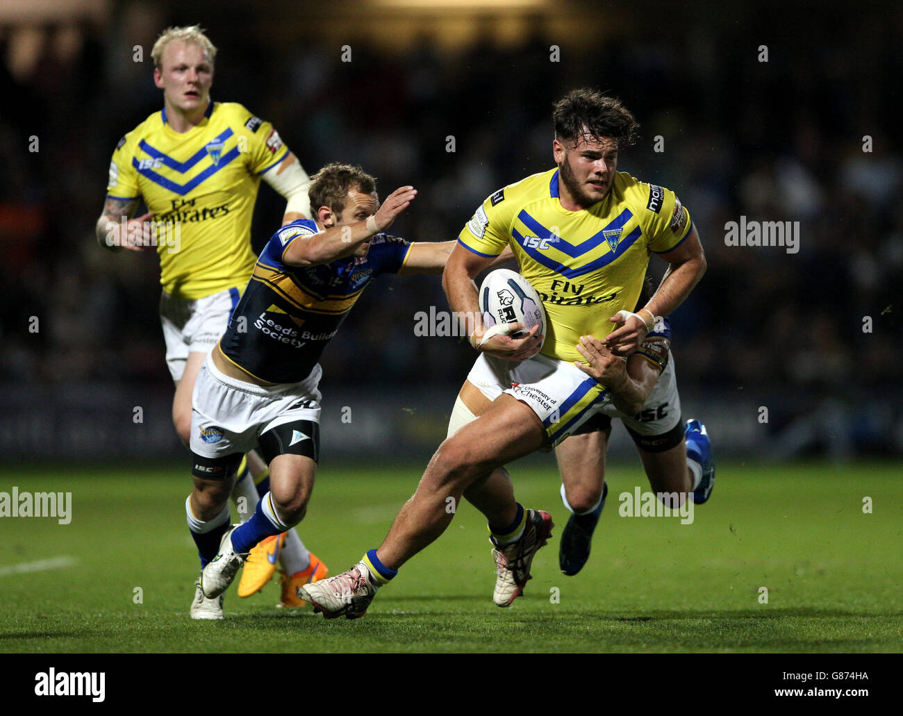 Warrington Wolves' Joe Philbin (right) is tackled by Leeds Rhino's Rob Burrow (left) during the First Utility Super League, Super 8s match at Headingley Carnegie, Leeds. Stock Photo