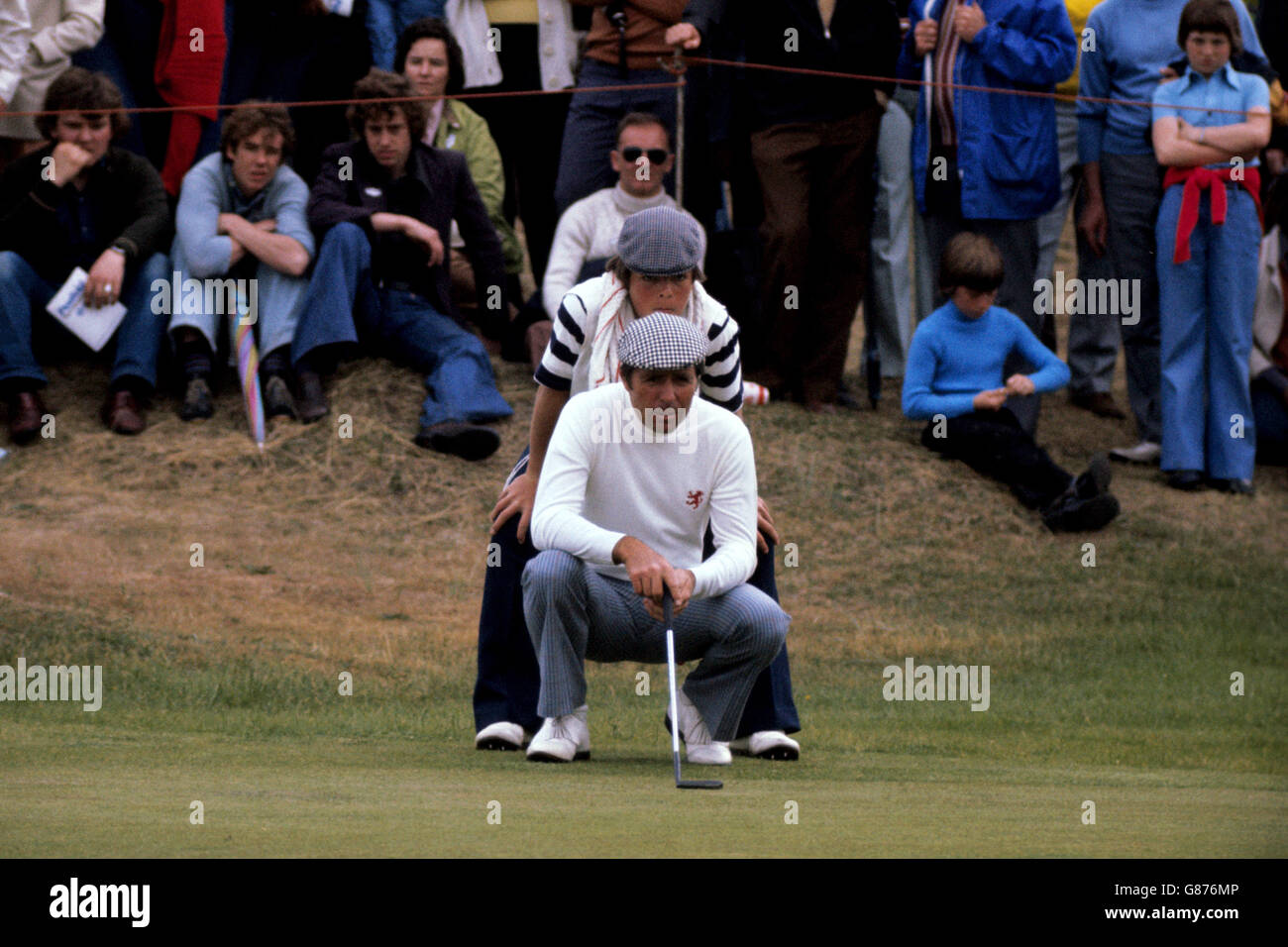 Gary Player and his caddy, son Wayne, line up a putt from the edge of the 17th green Stock Photo