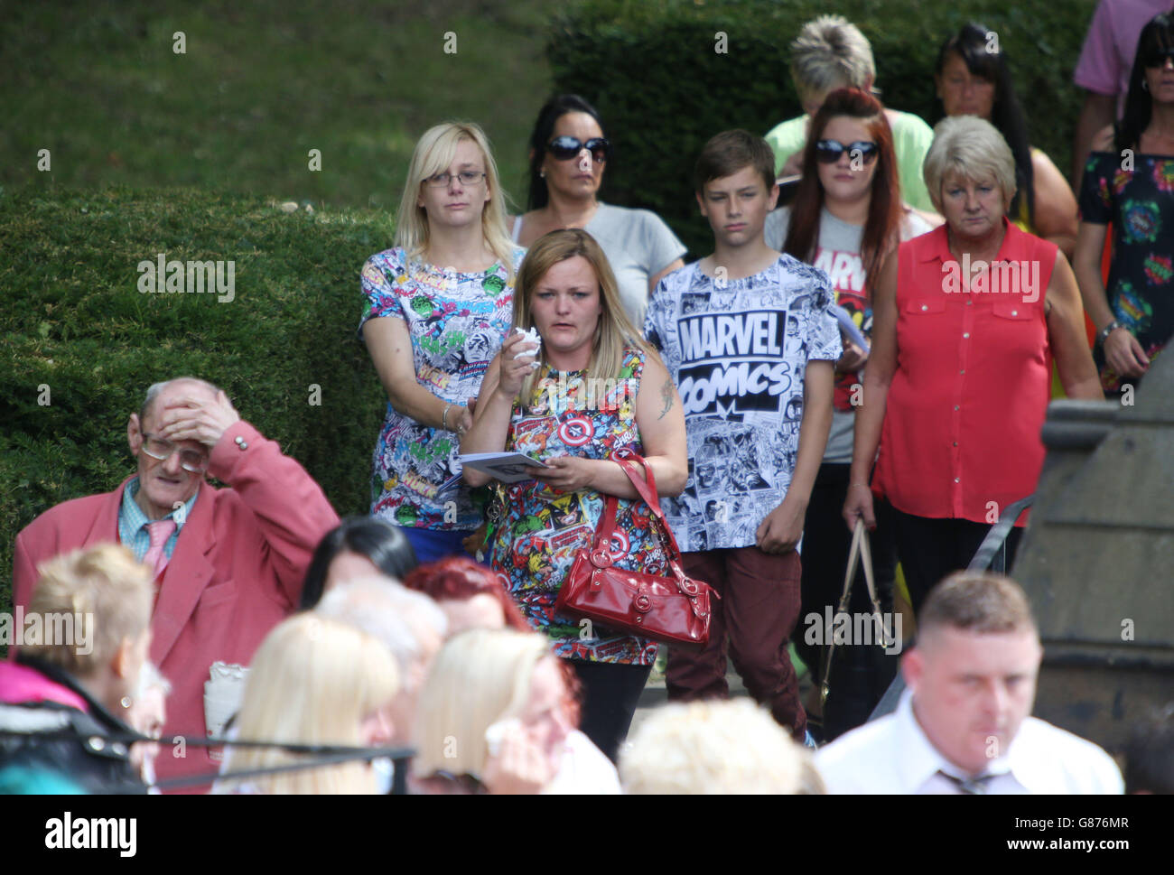 Mourners wearing superhero tshirts following the coffin of seven year old Conley Thompson as it