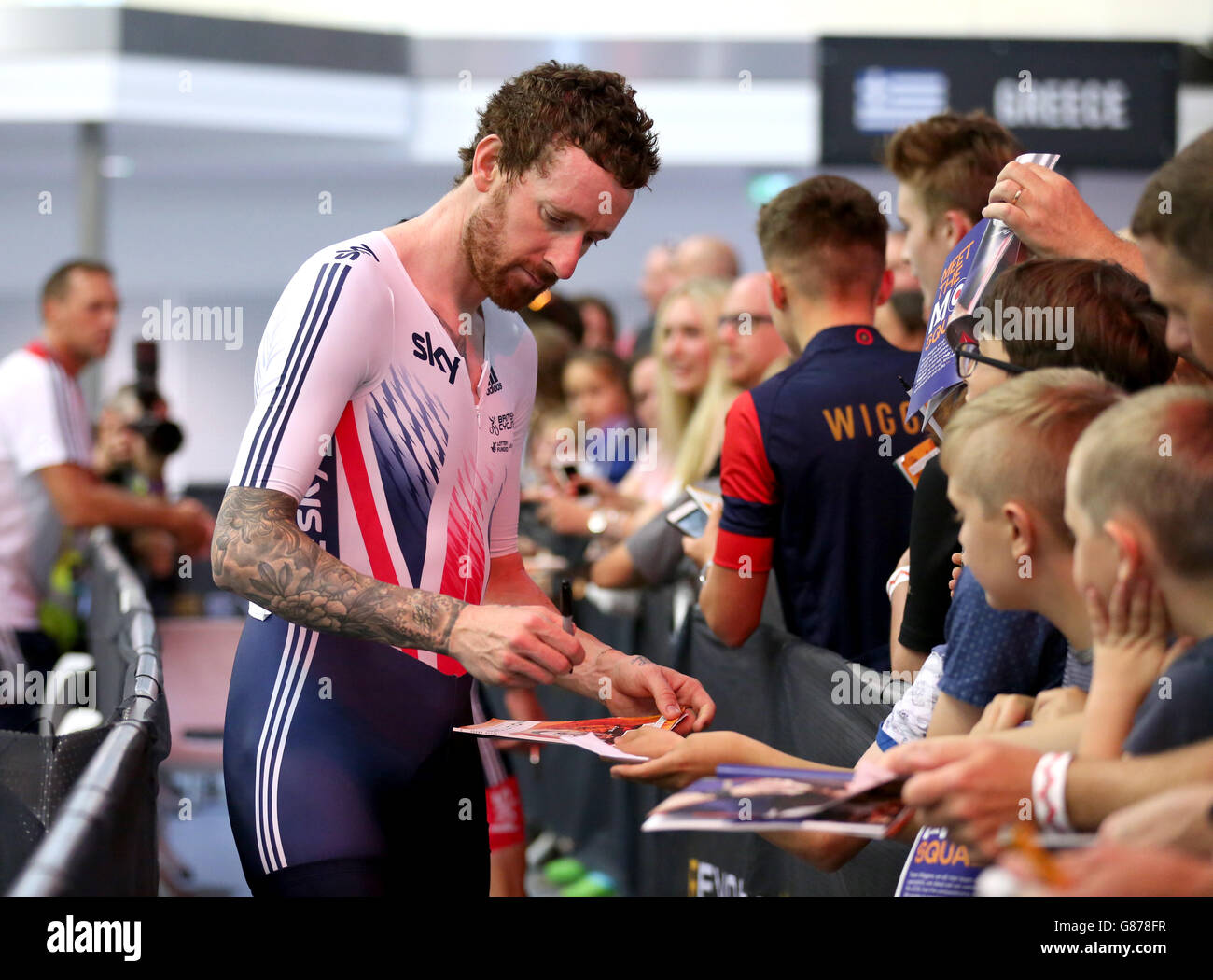 Team Great Britain's Sir Bradley Wiggins signs autographs for fans after winning the Madison during day three of the Revolution Series at Derby Arena. Stock Photo