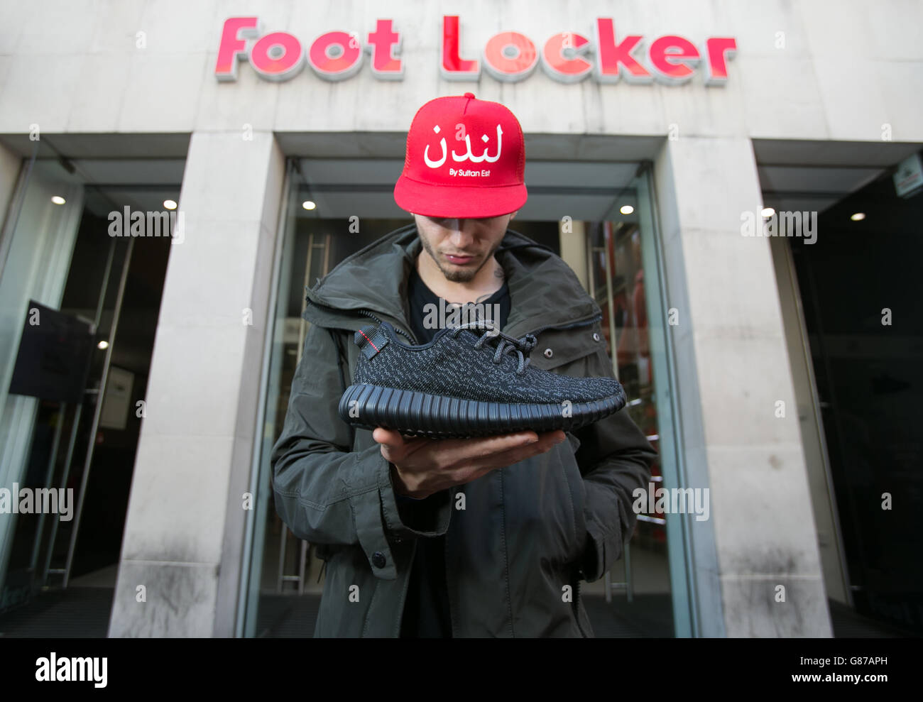 Sultan Est, 23 outside Foot Locker in Oxford Street, London, with his new pair of limited addition Adidas Yeezy Boost 350 trainers, designed by musician Kanye West. Stock Photo