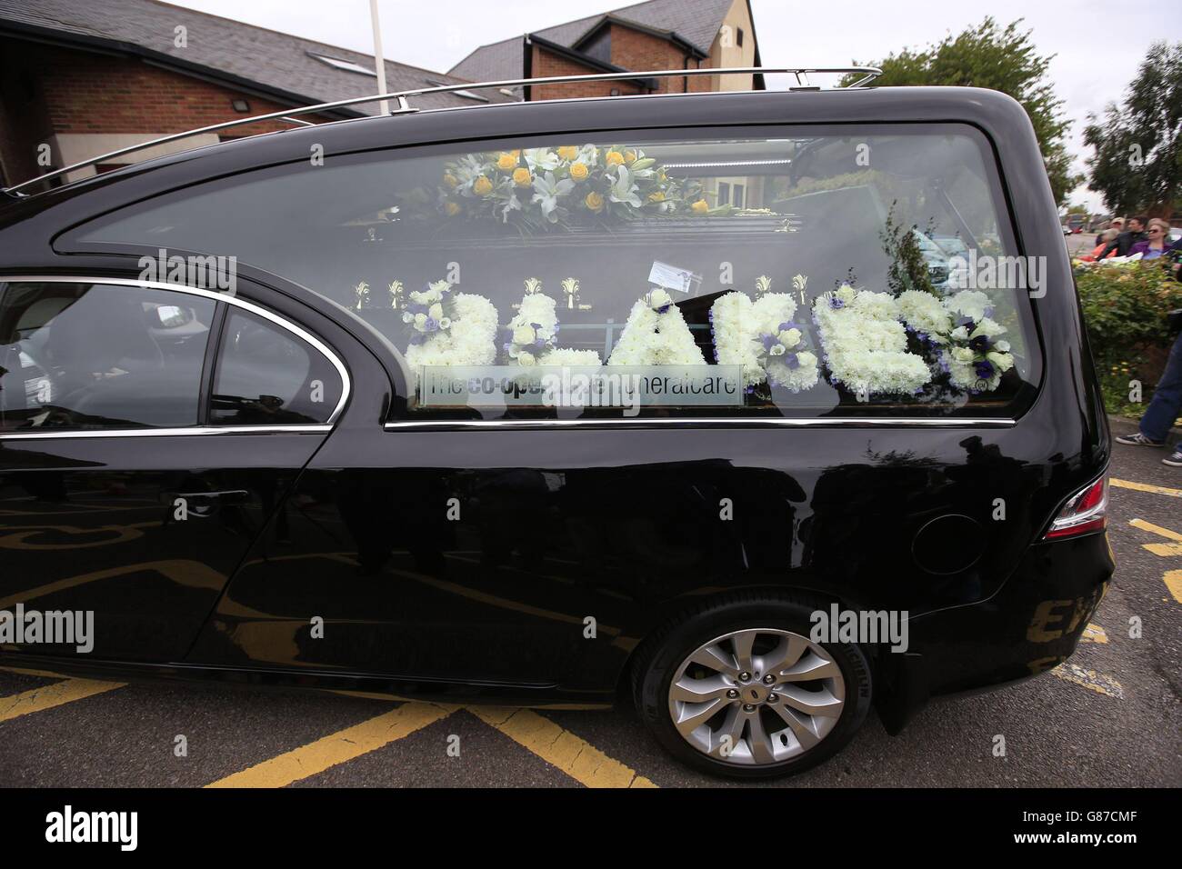 A hearse carrying the coffin of actor Stephen Lewis, known for his role as Inspector Cyril 'Blakey' Blake in sitcom On The Buses, arrives at Our Lady of Lourdes church in Wanstead, east London. Stock Photo