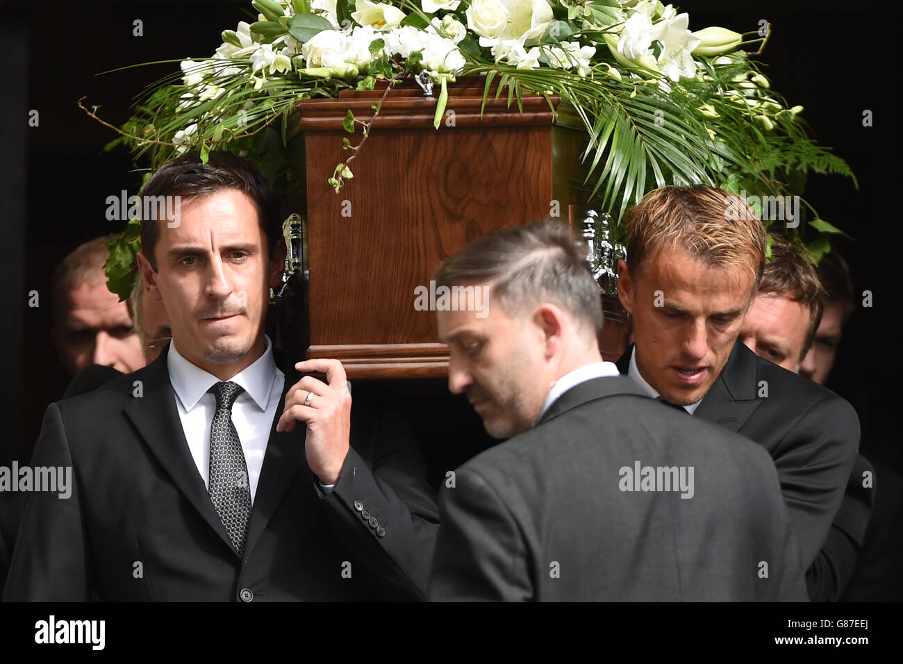 Gary Left And Phil Neville Right Carry Their Fathers Coffin Out Of Bury Parish Church In Greater Manchester After The Funeral Of Neville Neville Who Died After Suffering A Heart Attack Stock