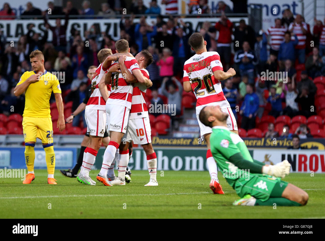 Soccer - Capital One Cup - First Round - Doncaster Rovers v Leeds United - Keepmoat Stadium. Doncaster Rovers' Andy Williams (back to camera) celebrates scoring his side's first goal of the game Stock Photo