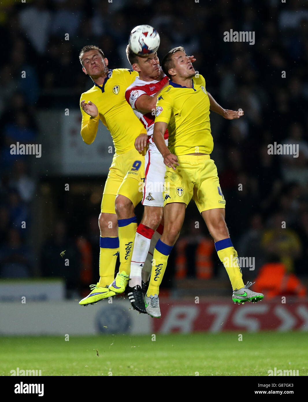 Soccer - Capital One Cup - First Round - Doncaster Rovers v Leeds United - Keepmoat Stadium. Leeds United's Scott Wootton (right) and Chris Wood contest a header with Doncaster Rovers' Andy Butler Stock Photo