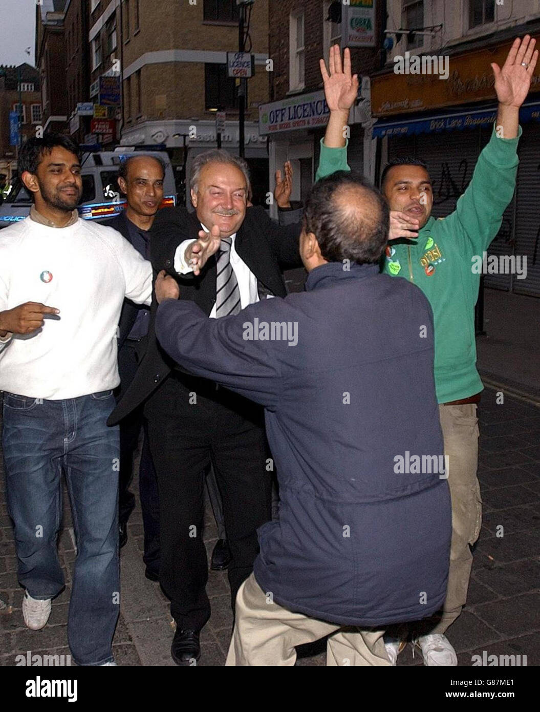 Former Labour MP and new Respect MP for Bethnal Green and Bow, George Galloway, greets supporters in London's Brick Lane. Galloway beat previous Labour MP Oona King for the seat which had been held by Labour since 1945. Stock Photo