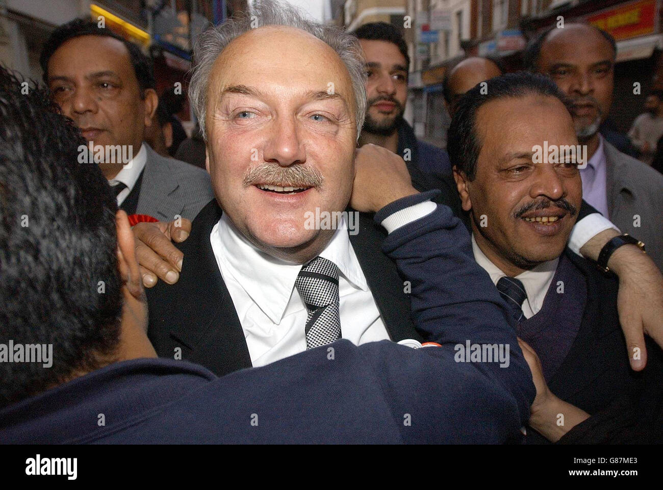 Former Labour MP and new Respect MP for Bethnal Green and Bow, George Galloway, greets supporters in London's Brick Lane. Galloway beat previous Labour MP Oona King for the seat which had been held by Labour since 1945. Stock Photo