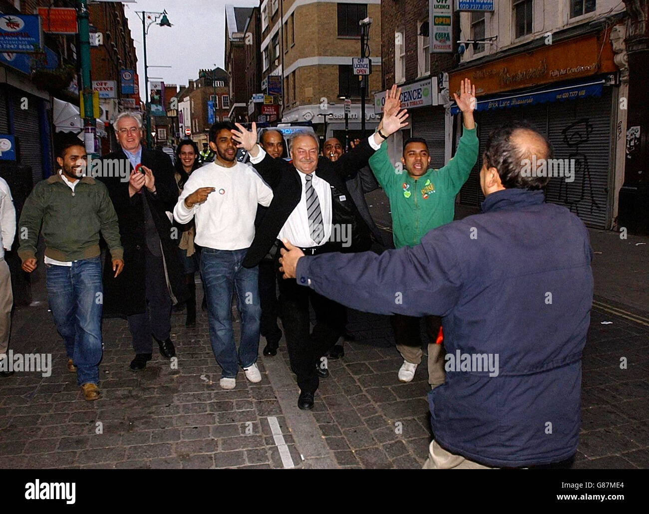 Former Labour MP and new Respect MP for Bethnal Green and Bow, George Galloway (centre), greets supporters in London's Brick Lane. Galloway beat previous Labour MP Oona King for the seat which had been held by Labour since 1945. Stock Photo