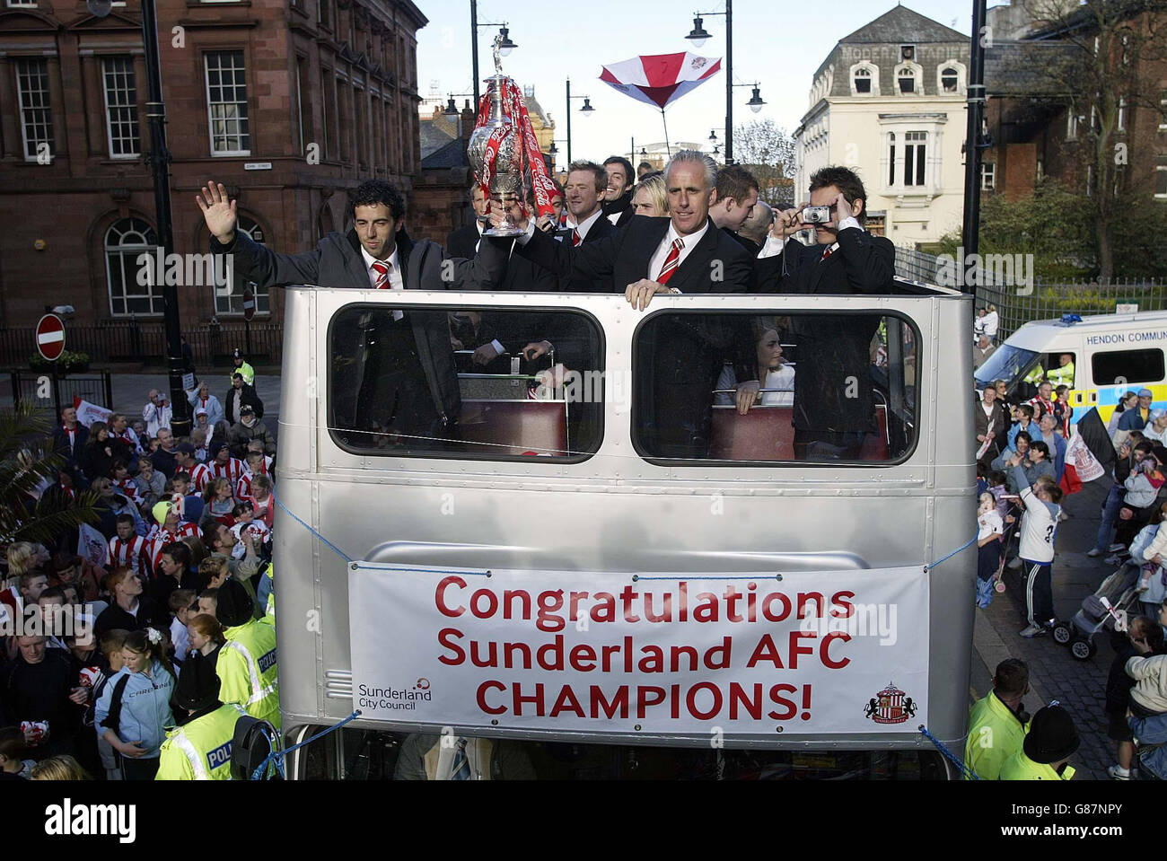 Sunderland manager Mick McCarthy (C) and Julio Arca (L) show off the Coca-Cola Championship trophy. Stock Photo