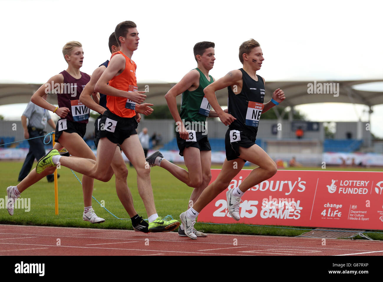 Athletes participate in the boys 3000 metre event at the Sainsbury's 2015 School Games at the Manchester Regional Arena. Stock Photo
