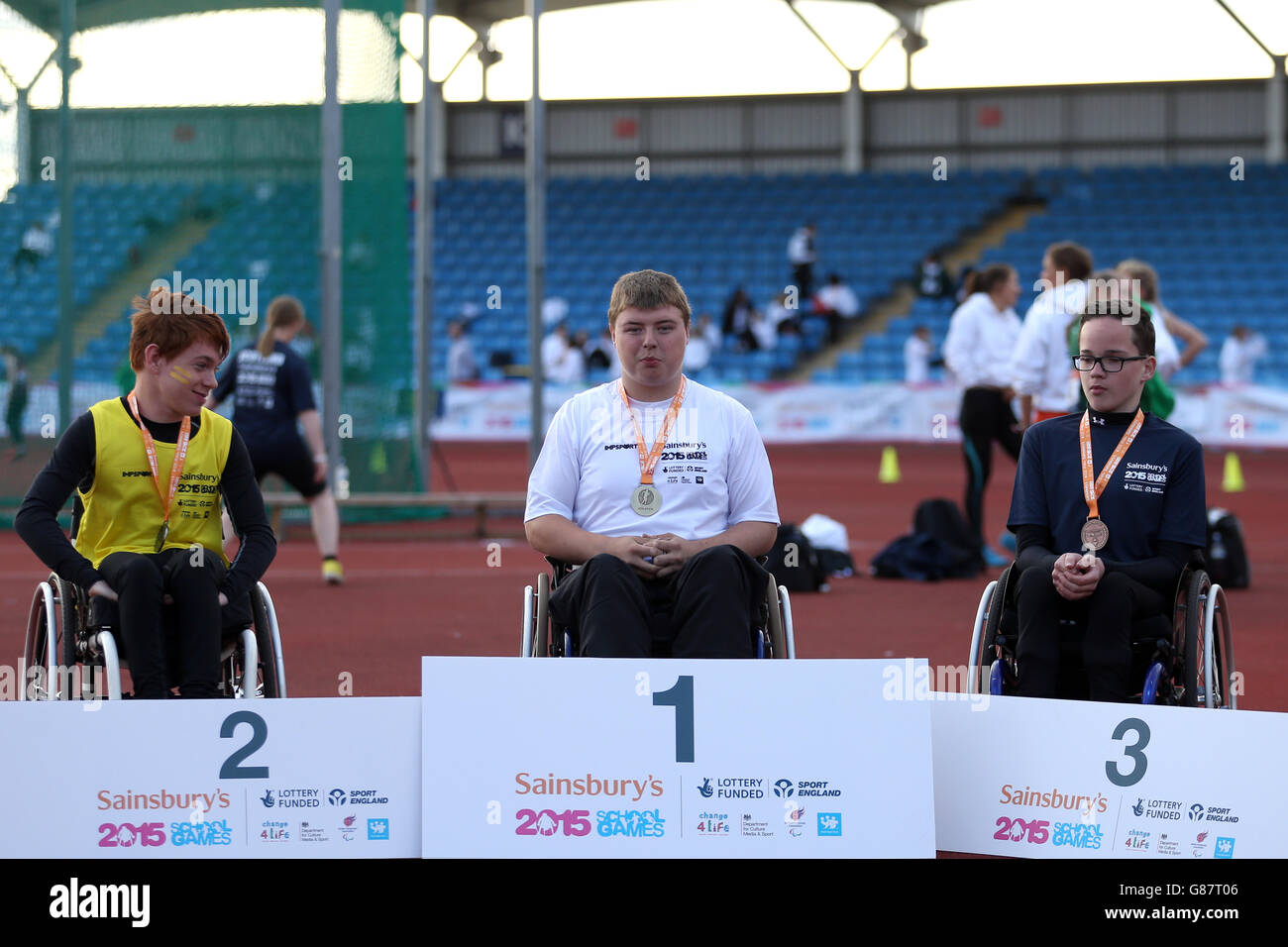 (l-r) England South West's Jaime Edwards, England South East's Joe Brazier and Scotland's Luke Deighan receive their boys 800 metre wheelchair medals during the medal ceremony at the Sainsbury's 2015 School Games at the Manchester Regional Arena. Stock Photo
