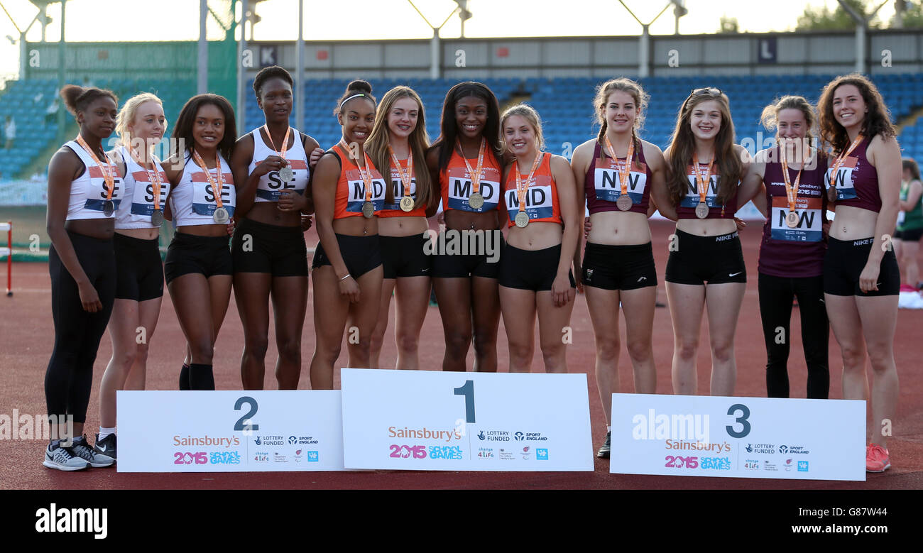 (l-r) England South East, England Midlands and England North West receive their girls 4 x 100 metre medals during the medal ceremony at the Sainsbury's 2015 School Games at the Manchester Regional Arena. Stock Photo