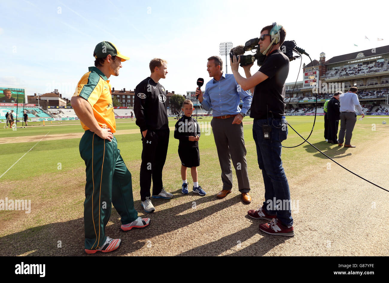 The Surrey match day mascot tosses the coin before the match with Dominic Cork working for Sky Sports, Surrey captain Gareth Batty (second left) and Nottinghamshire captain Chris Read (left) Stock Photo
