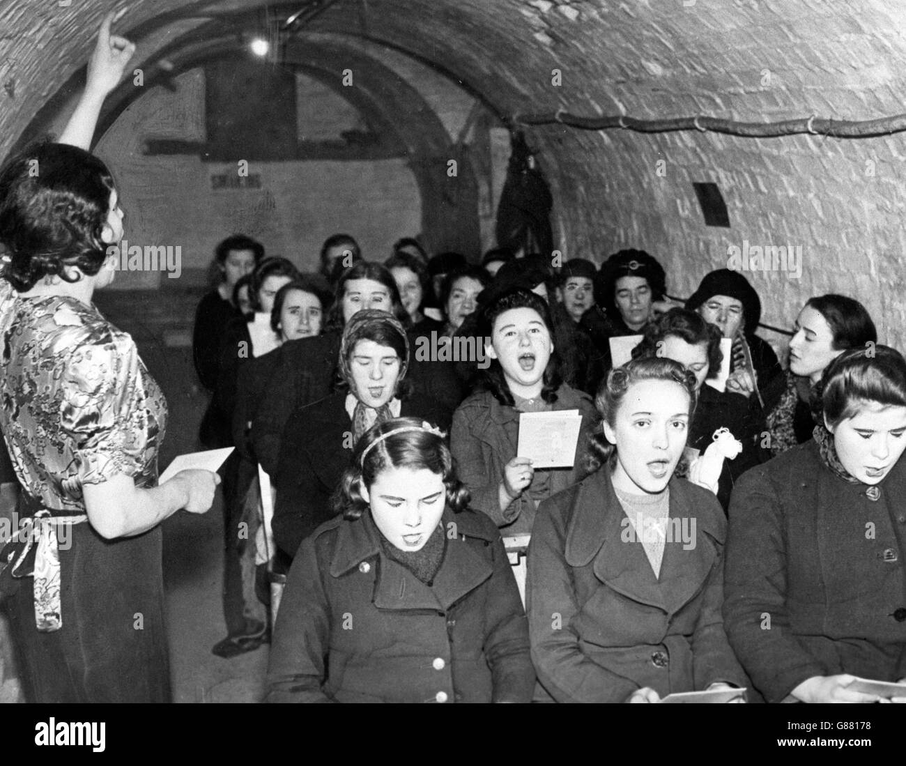 A singing class organised by the LCC takes place in an underground shelter in London. Stock Photo