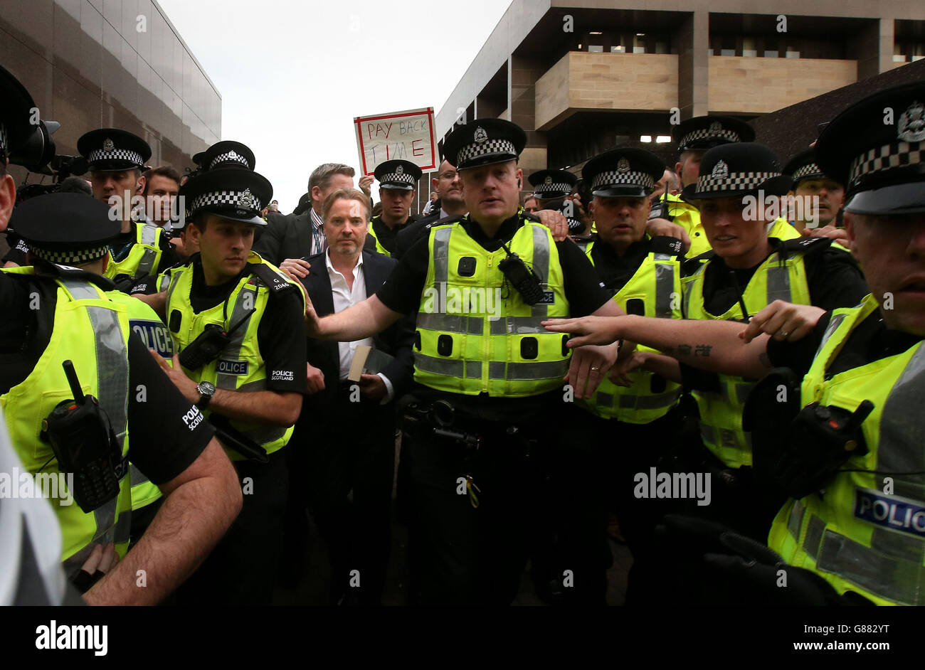 Former owner of Glasgow Rangers, Craig Whyte (centre left) leaves Glasgow Sheriff Court after he