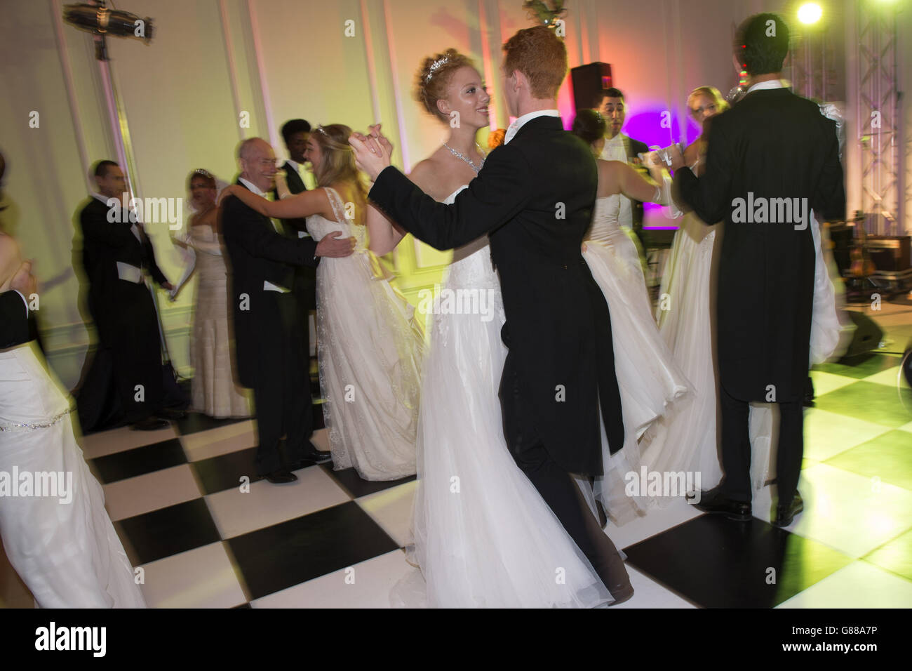 Debutantes dance the Viennese Waltz at the Queen Charlotte's Ball, in Kensington Palace, London. The Ball is the culmination of the debutante season, which traditionally introduced the daughters of British nobility into society. Stock Photo