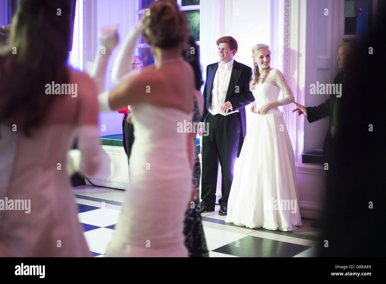 Debutantes dancing at the Queen Charlotte's Ball, in Kensington Palace, London. The Ball is the culmination of the debutante season, which traditionally introduced the daughters of British nobility into society. Stock Photo