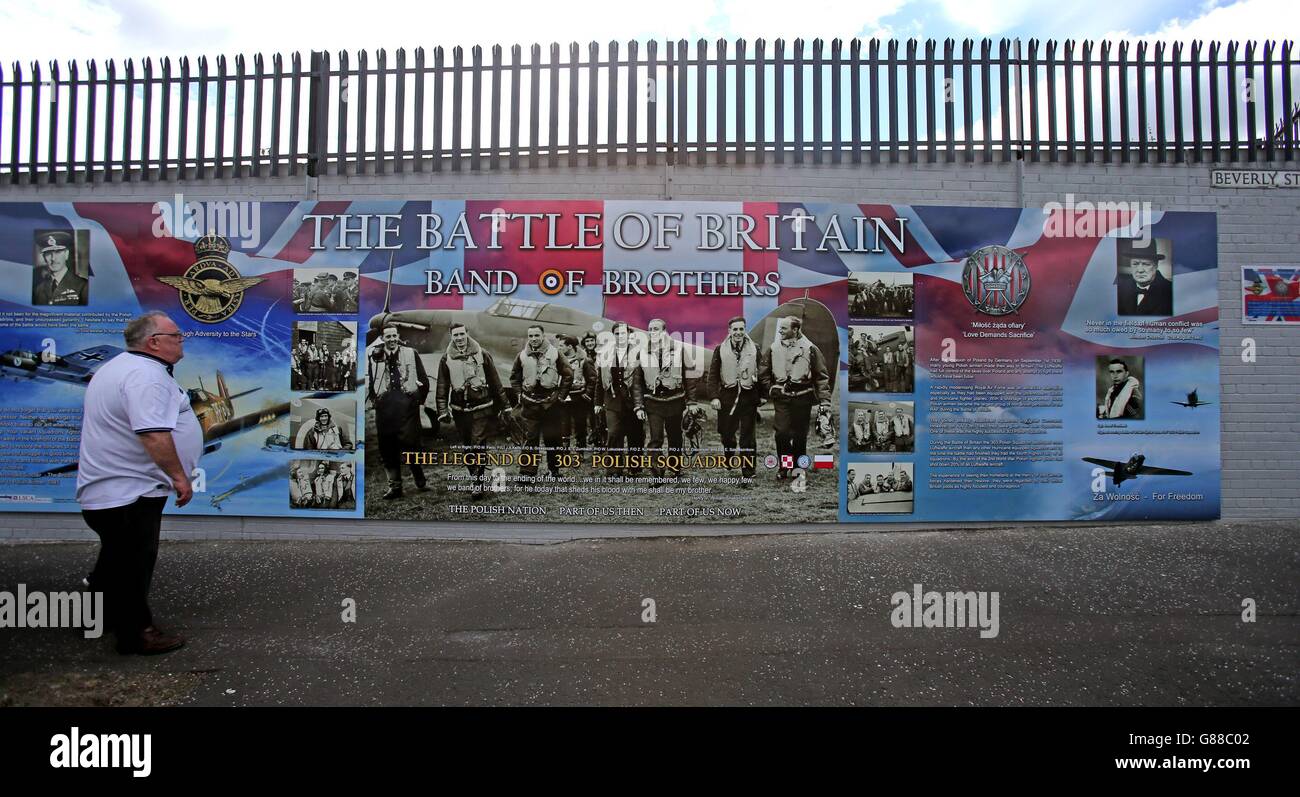 A man looks at an anti-racism mural entitled Band of Brothers which was unveiled on a peace wall off the Shankil Road Belfast on the 75th anniversary of the Battle of Britain to mark the valiant efforts of Polish airmen, who were stationed in Northern Ireland. Stock Photo