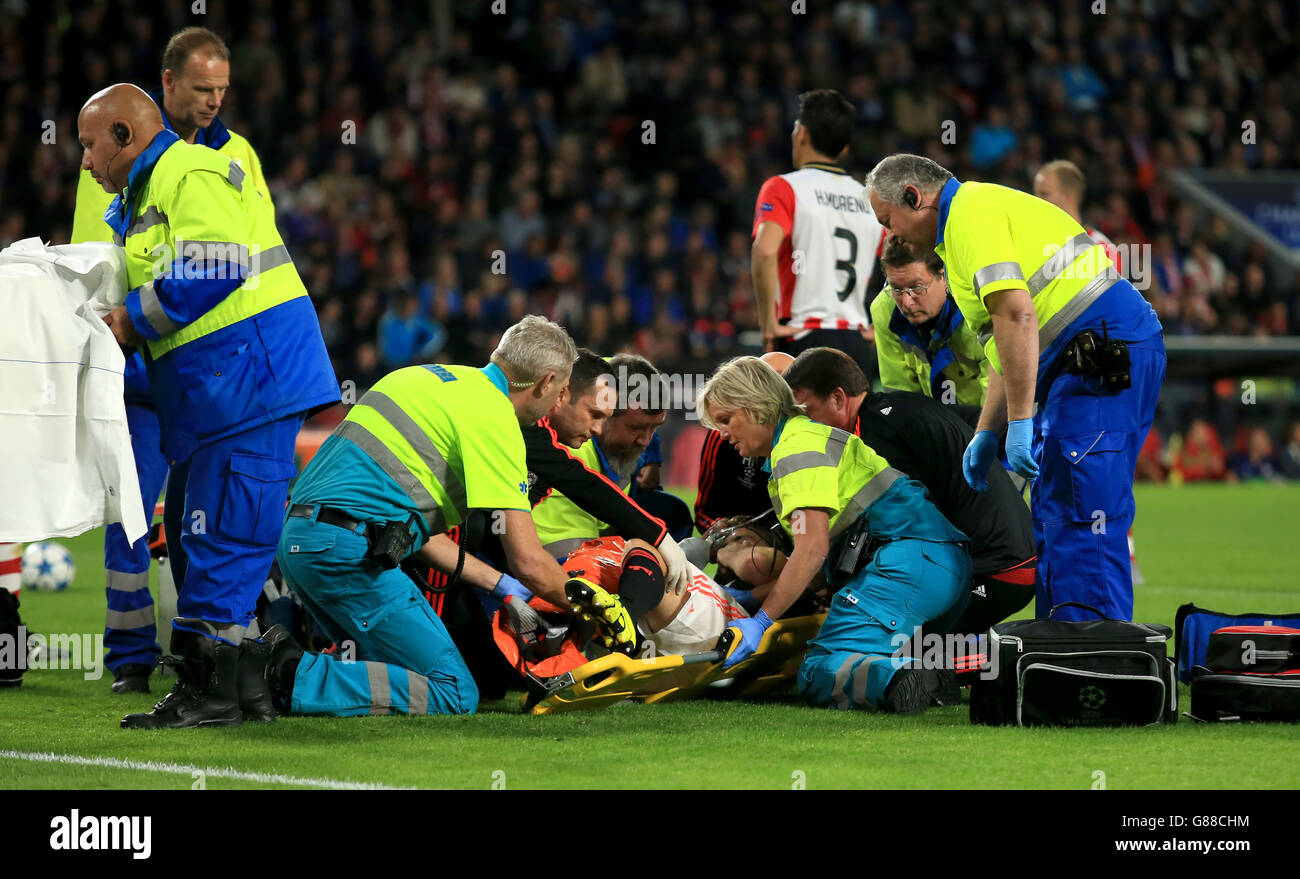 Manchester United's Luke Shaw is treated on the pitch after a challenge from PSV Eindhoven's Hector Moreno Stock Photo