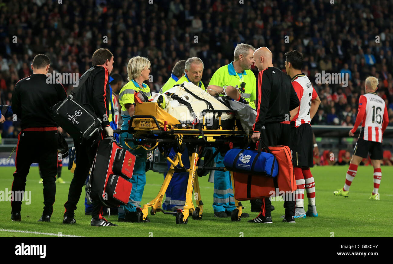Manchester United's Luke Shaw is wheeled off the pitch on a stretcher after a challenge from PSV Eindhoven's Hector Moreno Stock Photo
