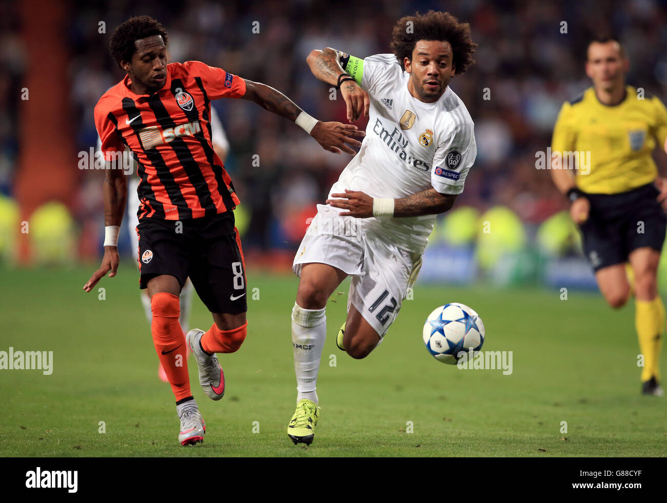 Real Madrid's Marcelo holds off challenge from Shakhtar Donestsk's Fred Stock Photo