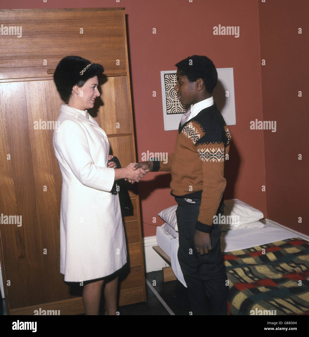 Princess Margaret, Countess of Snowdon, shakes hands with Alix Alexander (13), one of the boys of Fifth Boy's Hostel for the Fellowship of St. Christopher, Putney, London, which she opened. Stock Photo