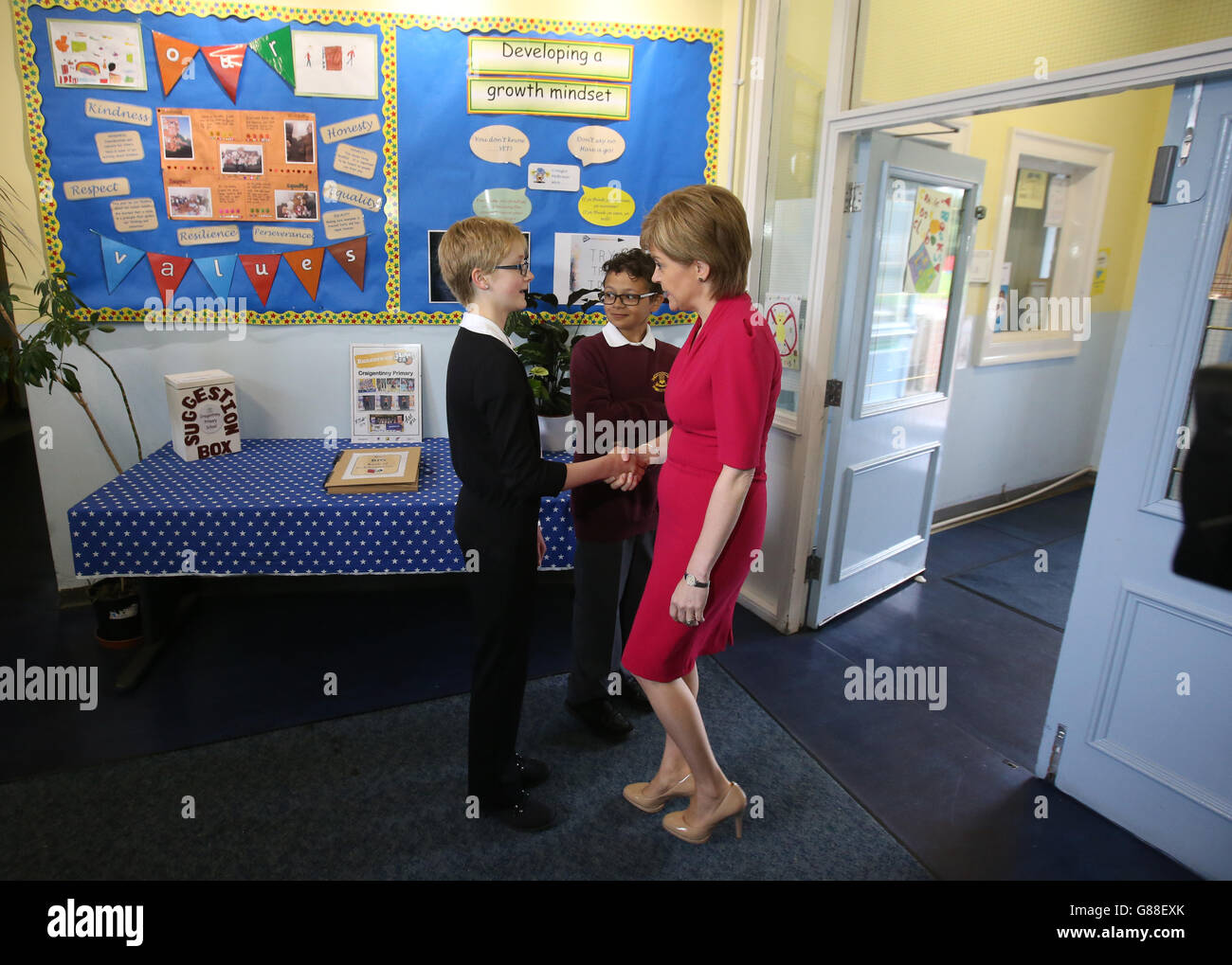 First Minister Nicola Sturgeon meets pupils Katie Boys and Rowan Nimmo (centre) at Craigentinny Primary School in Edinburgh, as she prepares to set out how she plans to use new powers that are coming to Holyrood both 'creatively and ambitiously'. Stock Photo