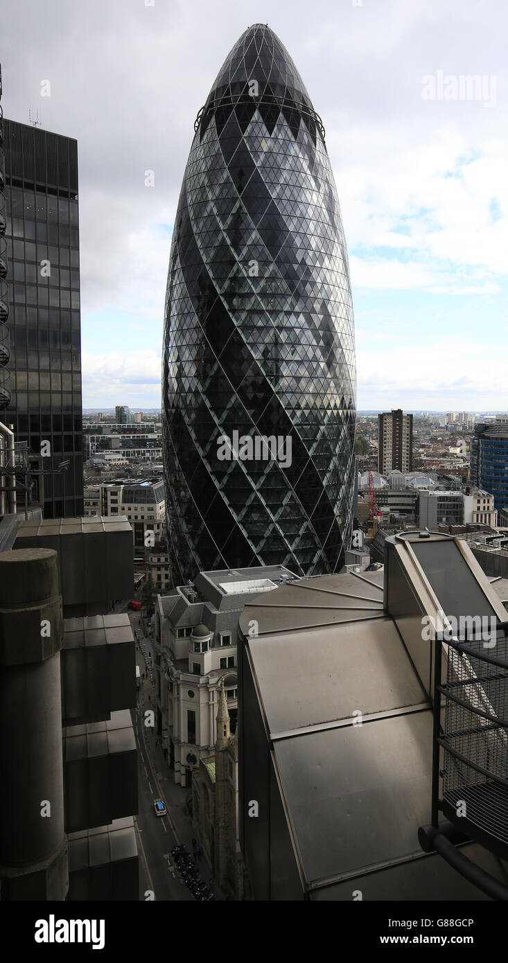 30 St. Mary Axe or 'The Gherkin' viewed from the roof of the Lloyds of London building, Lime Street, London. Stock Photo